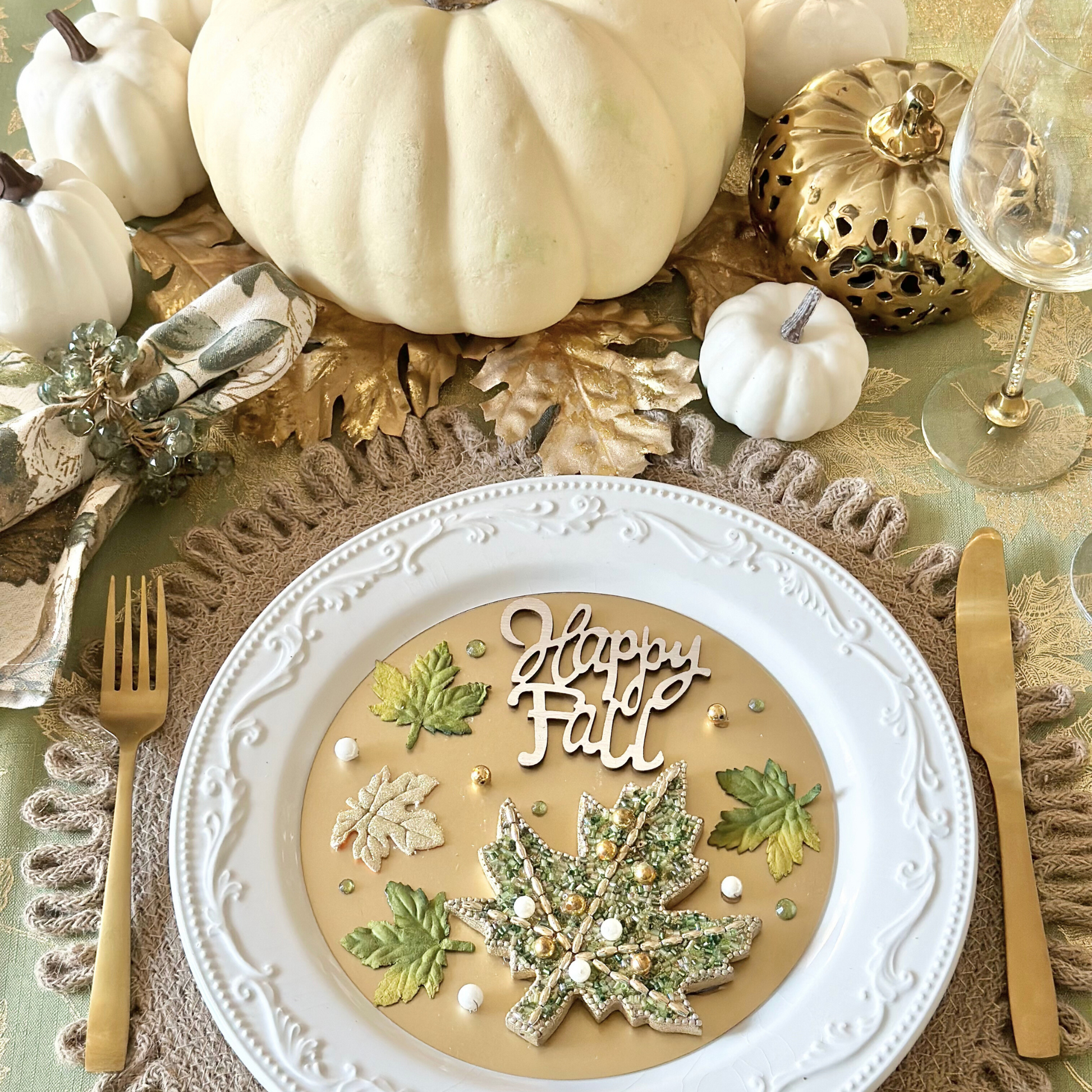 Happy Fall  Green and Gold Holiday Tablescape and Table Setting Decor accented with gold foil leaves and white and cream colored pumpkins