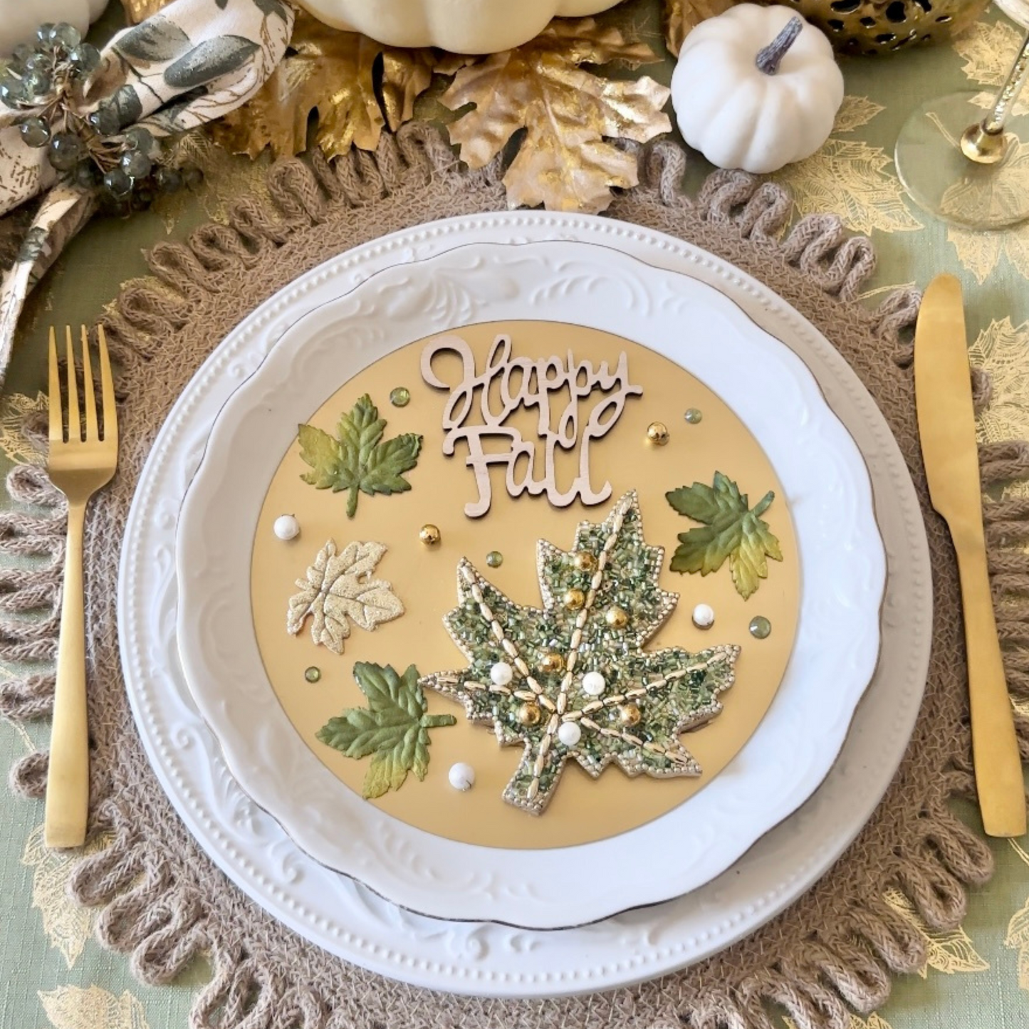 Happy Fall Green and Gold Holiday Tablescape and Table Setting Decor  accented with gold foil leaves and white and cream colored pumpkins